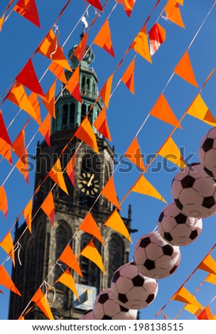 Orange flags (Dutch national color) and the Martinitoren during 2014 world soccer cup.