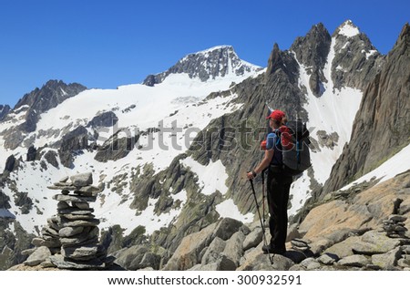 Female hiker enjoying the view in the mountains during a summer trekking vacation.