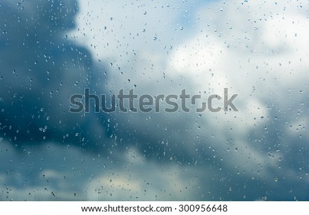 Raindrops on a window during bad, rainy weather.