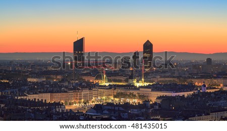 Place Bellecour and the towers of Part-Dieu in the city of Lyon, France, at dawn.