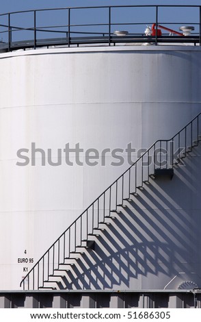 Shadows of a stair on an industrial silo.