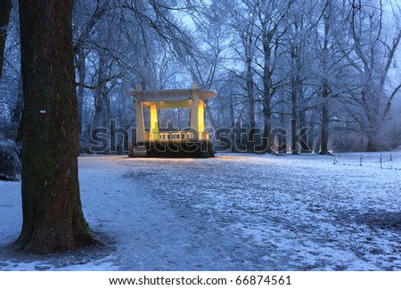 Warm lights of music chapel in a snow coverd park on a cold winter moring