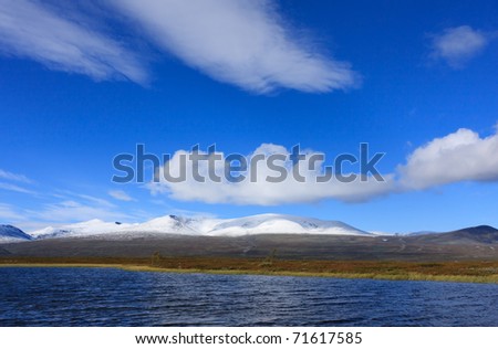 White clouds above the Arctic mountains of a National Park in Sweden.