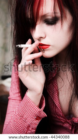 Young woman smoking a cigarette. it is quite possible that it was a drug addict