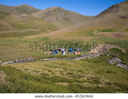 The tourist camp in the mountains, tents and cars
