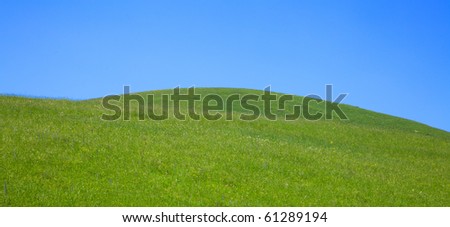Rolling green hills and blue sky