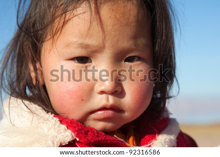 Mongolian girl is very serious-looking, the daughter of a nomad