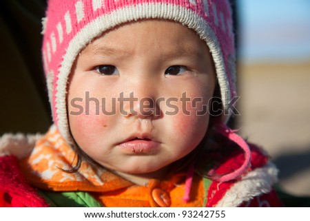 Mongolian girl is very serious-looking, the daughter of a nomad