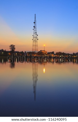 Telecommunications towers near the secret sky after the Sun\'s reflection in a pond.