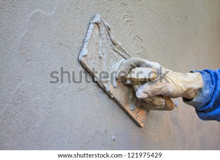 construction notched trowel with white cement mortar for tiles work