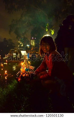 BANGKOK, THAILAND - NOVEMBER 28: People float banana leaves lanterns in the river to worship river goddess in Loy Kratong festival on November 28, 2012 in Bankok, Thailand.