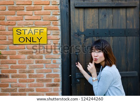 Cute Thai woman is trying to enter the staff room, which is a forbidden area.