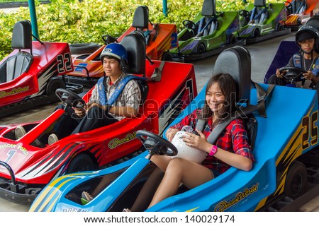 BANGKOK, THAILAND - 10 MAY 2013: unidentified Thai teens prepare to play go-kart at Dream World on May 10, 2013. Dream world is a famous amusement park in Thailand.