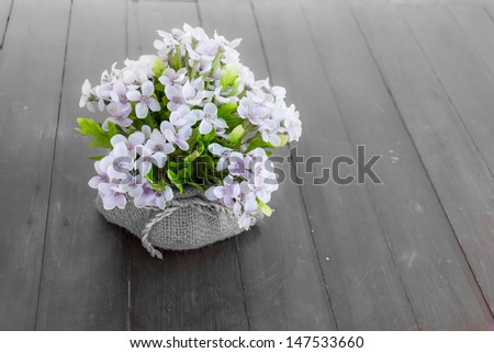 Artificial Flowers in the sack pot with empty space for fade background