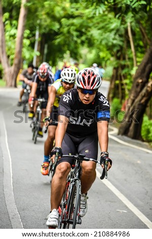 BANGKOK, THAILAND - 2 AUGUST 2014: Group of Thai mountain bikers is practicing on the rural street on August 2, 2014.