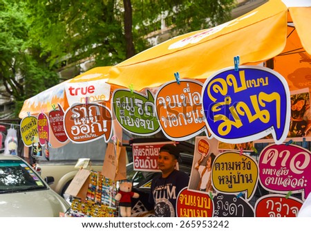 BANGKOK, THAILAND - 3 AUGUST 2014: Funny labels in Thai language on sale for college student graduation celebration in Thammasat university on August 3, 2014.