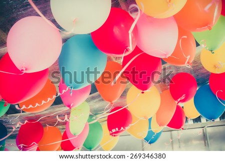 Colorful balloons floating on the ceiling of a party in childhood memory