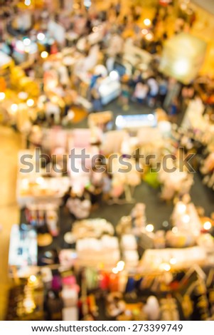 Blur background photograph of the ground floor with people and booths in an indoor building, shoot from above in top view in vintage color