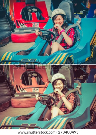 Cute Asian Thai girl is smiling with fun while driving Go-kart with speed from the starting point in playground racing track  in vintage and childhood color set. Go kart is a leisure motor sports.