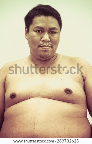 Fat naked upper body and belly stomach of an Asian African man showing proud expression on his face in white isolated background in retro style