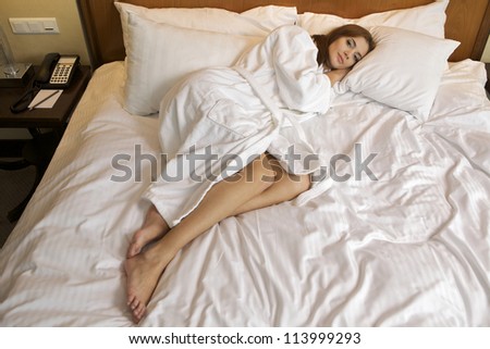 beautiful brunette woman in bed