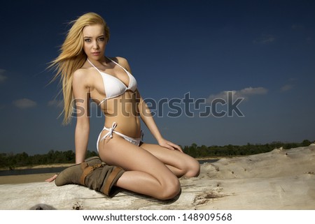 beautiful blonde woman in white bikini on the beach