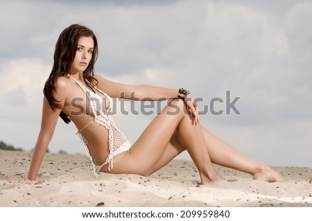 young adult fashion pretty and attractive brunette sexy woman in white bikini on the beach