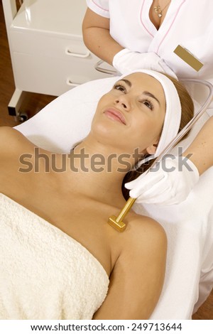 Portrait of young adult attractive and sensuality brunette pretty girl receiving laser therapy procedure. Woman getting laser face treatment in medical spa center skin rejuvenation concept