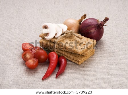 food components composition containing diet bread, red and white onion red peppers, cherry tomatoes and sliced mushrooms