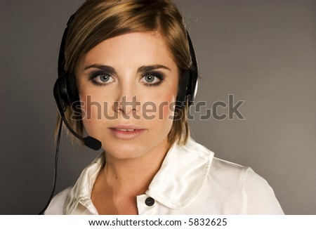 beautiful girl with blondie hair with headphones and microphone wearing white blouse