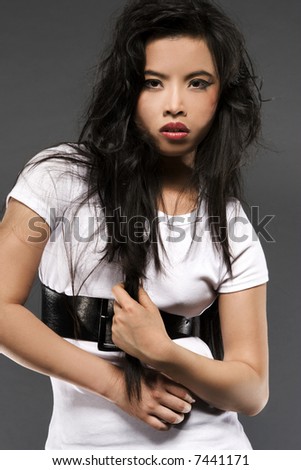 oriental model posing on grey background