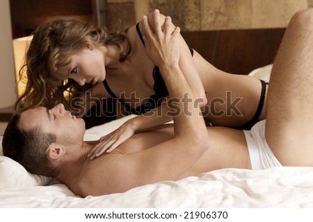 stock photo intimate young couple during foreplay in bed