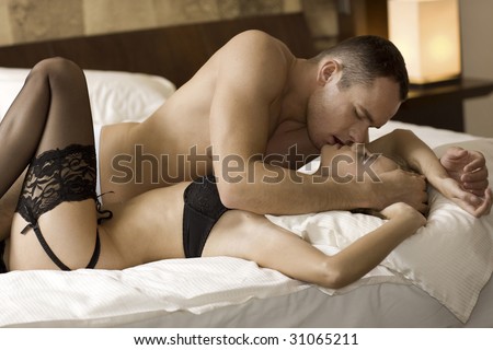 stock photo intimate young couple during foreplay in bed