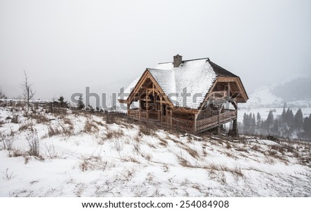 Hut in the snow.  background with snowy landscape. Ukraine