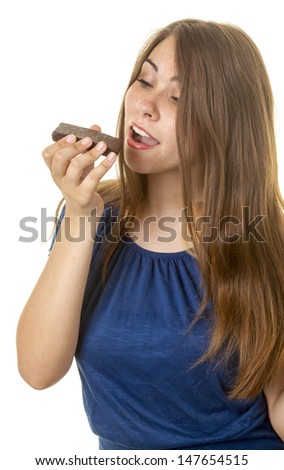 Attractive young woman eating a brownie or cake
