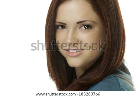 Headshot portrait of an attractive young woman with red hair and a green outfit.