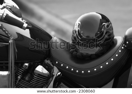 Helmut and gloves on a seat of a cruiser style motorcycle