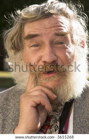 Elderly man with white beard with an expression of enlightenment.