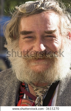 Elderly man with white beard and a warm smile.