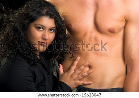 Black haired woman admiring the physique of a man