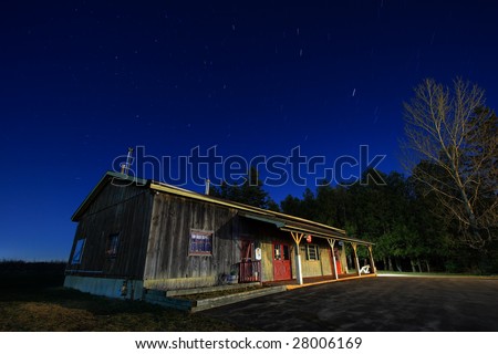 Farm store at night with northern sky in the background.