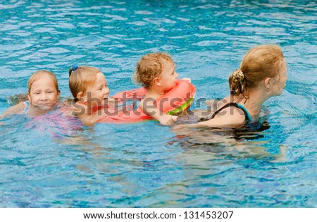 happy family playing around in the pool