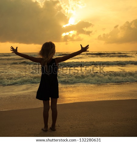 happy girl standing on the beach on the dawn time