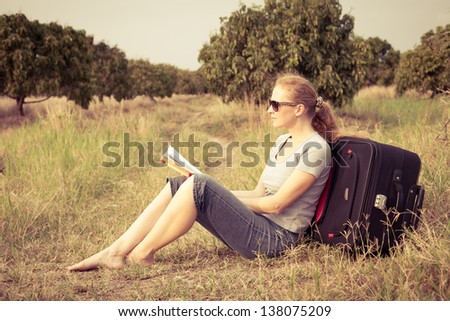 woman sitting reading a book on nature