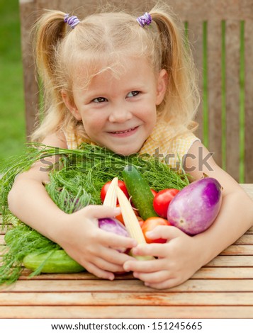 Happy little girl with vegetables . Concept of healthy food.
