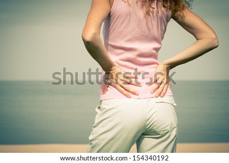 Beautiful  woman standing on the beach enjoying the sun