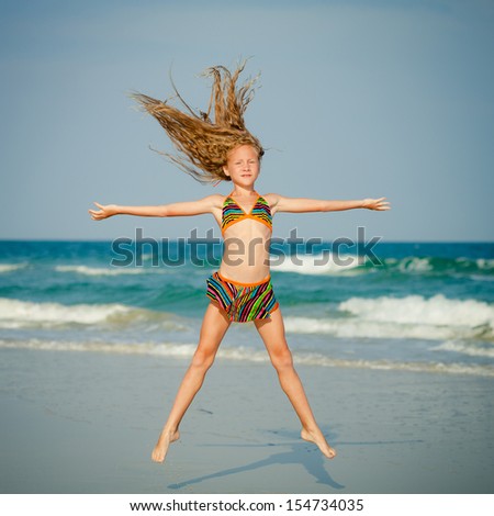 flying jumping beach girl at blue sea shore in summer vacation in the day time