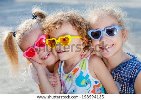 Brother And Sisters Together Forever. Three happy children in the sunglasses