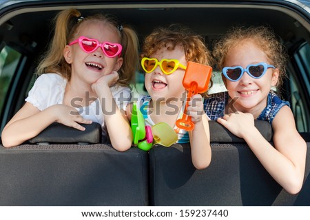 two little girls and boy sitting in the car two little girls and boy sitting in the car