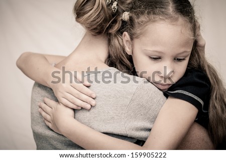sad daughter hugging his mother